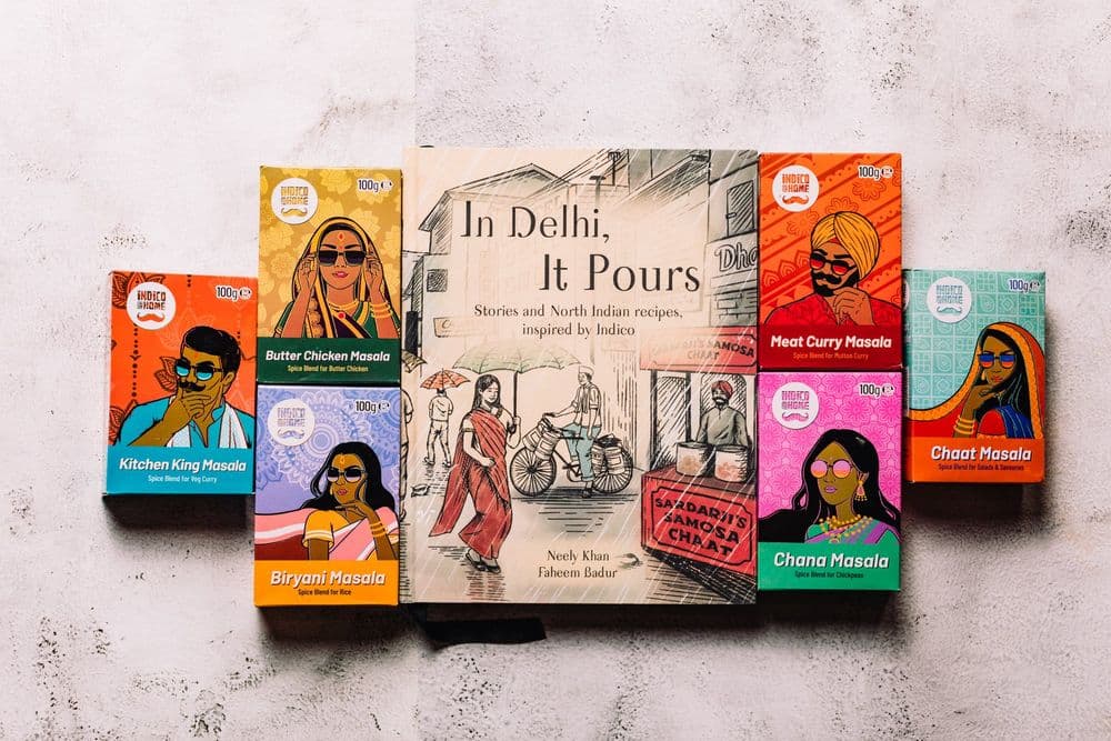 The In Delhi, It Pours cookbook surrounded by Indico spice boxes