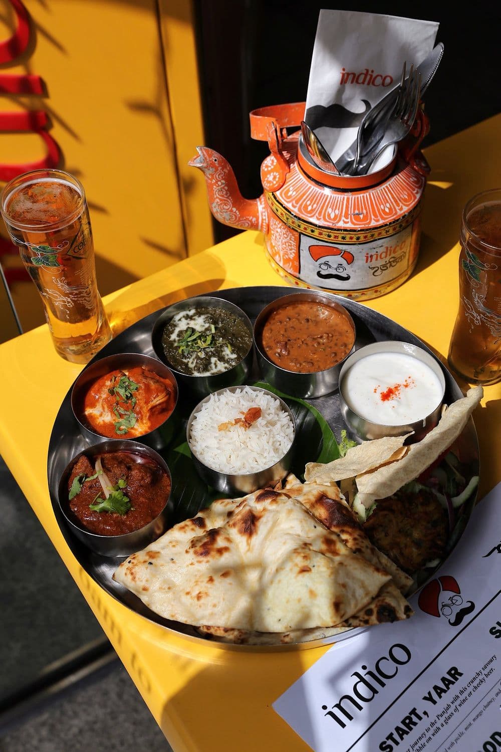 Hands over a full thali