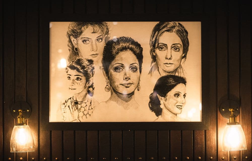 Portraits of Bollywood actresses on the restaurant wall